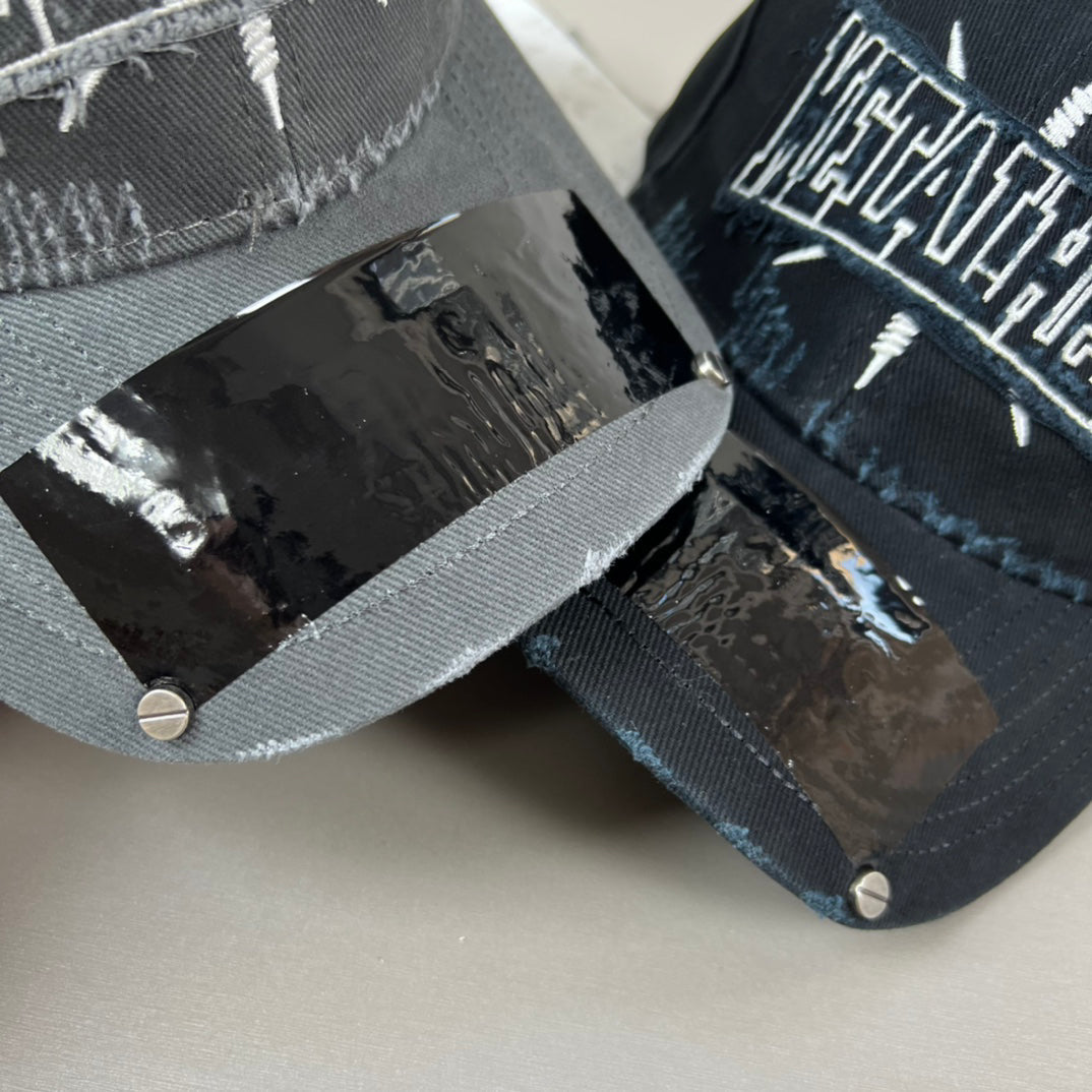 Black distressed cotton cap with metal graphic and glossy shield brim